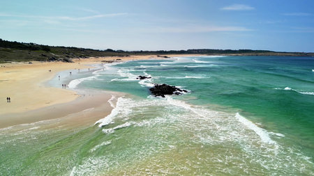 Enjoy this stunning aerial view capturing the serene beach featuring vibrant turquoise waters and...