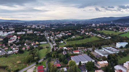 Aerial footage showcases the blend of dynamic urban areas and lush landscapes filled with vibrant greeneryの写真素材