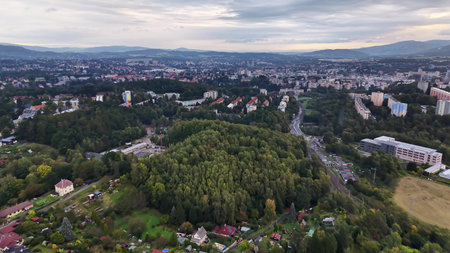 An absolutely stunning aerial shot showcasing a detailed cityscape that beautifully blends into lush green areas nearbyの写真素材