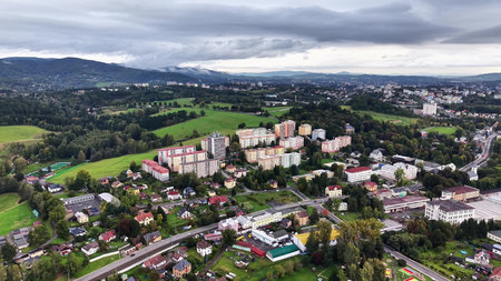 An enthralling aerial shot beautifully capturing urban buildings nestled amidst stunningly lush...