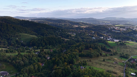 An expansive aerial perspective vividly showcasing the stunning hills and lush verdant landscapes under a clear skyの写真素材