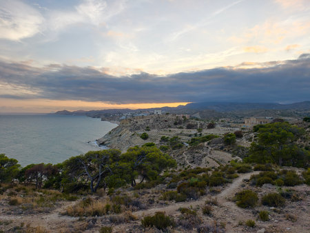 The breathtaking coastline at sunset truly highlights the rugged terrain and the tranquil waters beautifullyの写真素材