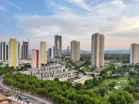 Stunning aerial view of contemporary urban development featuring vibrant skyscrapers and green spaces.の写真素材
