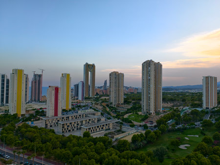 A breathtaking skyline featuring vibrant highrise buildings beautifully set against a stunning sunset backdropの写真素材