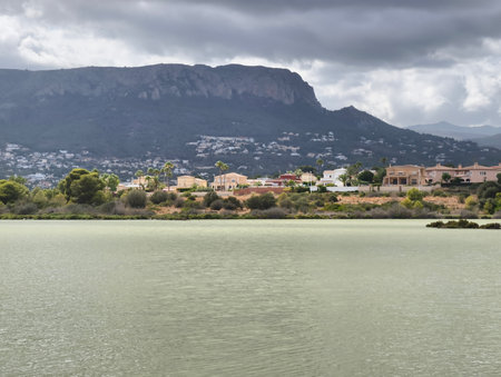 A picturesque landscape featuring a serene lake with a mountain backdrop, reflecting nature's beauty.の写真素材