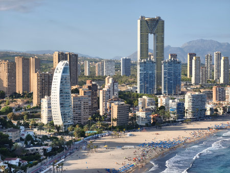 A stunning panoramic view of a vibrant coastal city with contemporary buildings and a beautiful beach.の写真素材