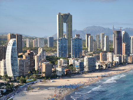 You can see a stunning coastal view of a vibrant city skyline that beautifully complements a gorgeous beachの写真素材