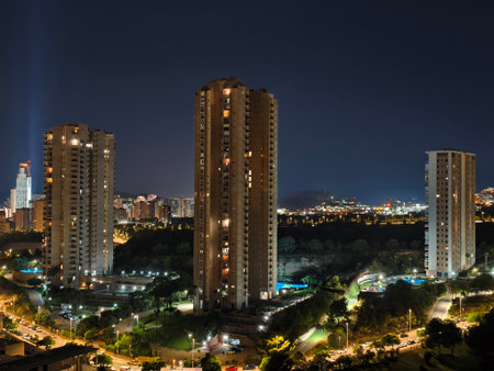 A breathtaking nighttime view that showcases towering buildings alongside vibrant and colorful city lightsの写真素材