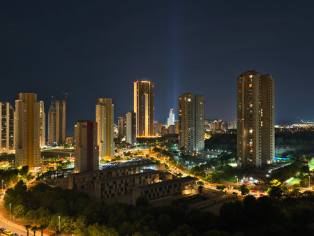 A vibrant urban skyline at night showcases towering buildings and illuminated streets, creating a stunning sceneの写真素材