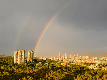 city with vibrant rainbow hues, uplifting urban scene with vibrant rainbow and stormy cloudsの写真素材