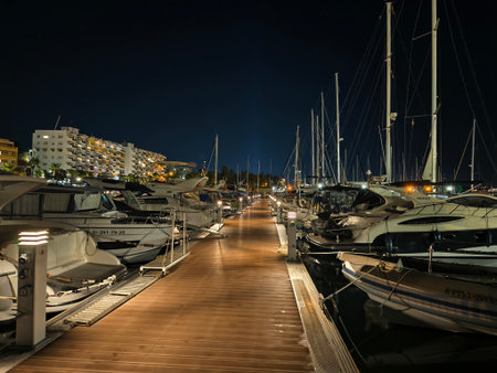 sailboats along serene skyline, scenic marina pathway leads to city skyline and tranquil reflectionsの写真素材
