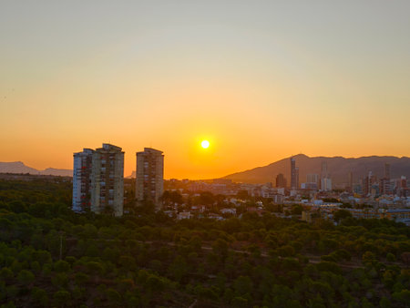 dusk paints horizon with warm light, tranquil evening scene with warm golden hues over hillsの写真素材