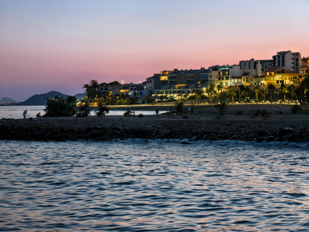 sunset scene, scenic sunset over rocky shoreline with gently breaking waves and illuminatedの写真素材