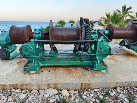 weathered winch and fisherman setup at shoreline, rustic winch overlooking sea with haulingの写真素材