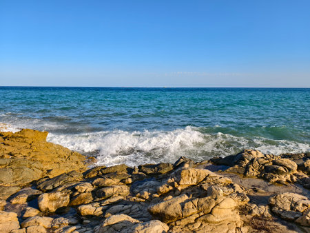 energetic seaside surf scene, intense ocean surf crashing over rocks with motion and contrastの写真素材