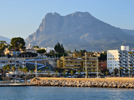 scenic shoreline with mountains and water, resort by water with mountain views and sunny terracesの写真素材