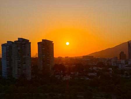 cinematic sunset with contrasting silhouettes, dramatic cityscape at sunset with vivid contrastsの写真素材
