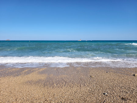 serene coastal landscape evokes tranquility, peaceful seascape with expansive horizon and clear skyの写真素材