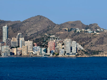 vibrant beach scene, lively coastal area under sun, bustling seaside streets with hotelsの写真素材