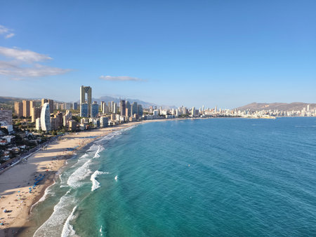 peaceful coast with cityscape, tranquil seaside landscape showcasing urban skyline and open seaの写真素材