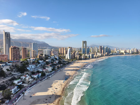 sunlit coastal scene, golden dawn over seashore, tranquil morning by sunlit coastlines and mountainsの写真素材