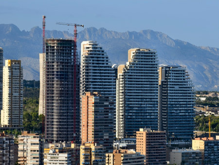 urban construction ongoing, active construction of glass skyscrapers transforming city skylineの写真素材
