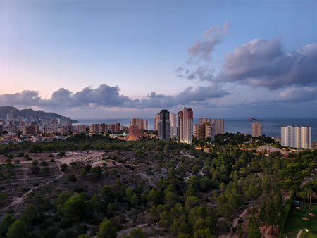 warm light illuminating urban coastal landscape, calm seaside cityscape bathed in golden sunsetの写真素材