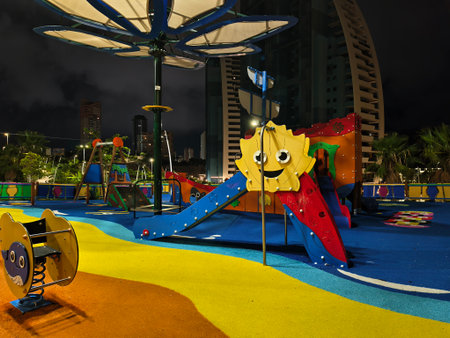 vibrant playground scene, bright urban playground with cheerful sun sculpture and safety flooringの写真素材