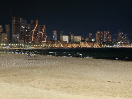 urban horizon with tranquil seaside, twilight city skyline blending calming ocean with eveningの写真素材