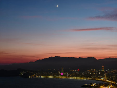 night scene description, coastal city at night, nighttime coastal boulevard with reflectionsの写真素材