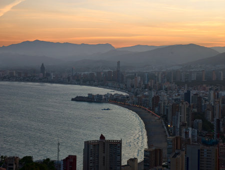 misty evening reflections, softly colored evening scene with shimmering water and distant cityの写真素材