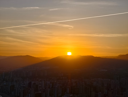 sunrise softly illuminates peaceful city valley, early morning tranquility with sunriseの写真素材