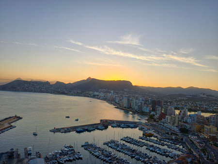 warm sunset over calm harbor, tranquil sunset casts warm glow on boats and coastal water reflectionsの写真素材