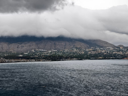 turbulent weather backdrop illustrating dramatic stormfront above shoreline environmentsの写真素材