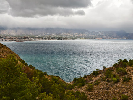 ocean under dark clouds, sea with choppy waters beneath towering dark cloudsの写真素材