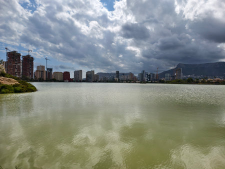 landscape with buildings, serene waterfront scene with highrise buildings and overcast weatherの写真素材