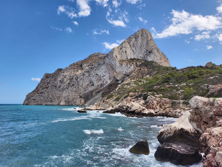 cliffside overlooking vibrant turquoise waters, rugged coast with boat and rocky shorelineの写真素材