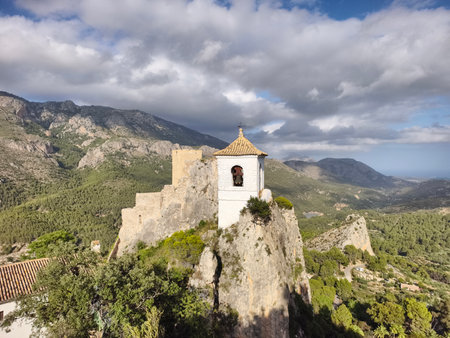 clifftop chapel with mountaintop views, rocky clifftop chapel showcasing panoramic mountain sceneryの写真素材