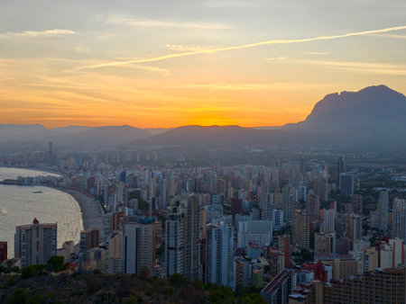 scenic bay sunset, captivating sunset scene over bay showcasing mountain silhouette and livelyの写真素材