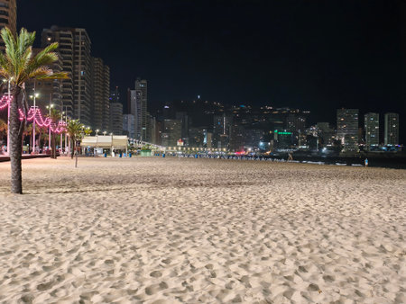 beach night scene, neonlit nighttime beach promenade, quiet beachfront at night with neon lightsの写真素材