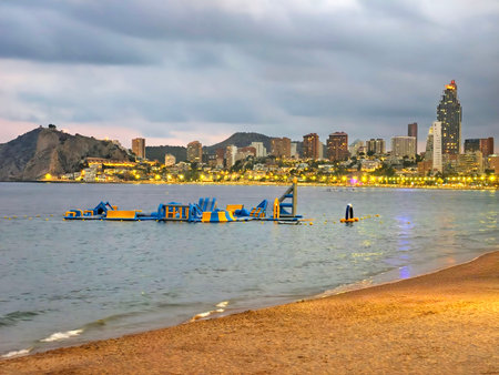 solitary individual practicing balance on paddleboard amid gentle dawn lighting and peacefulの写真素材