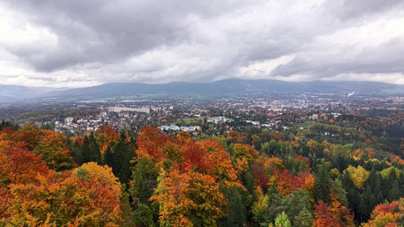 Autumn landscape showcasing city and nature contrast, Scenic view combining urban elements and colorful fall foliageの写真素材