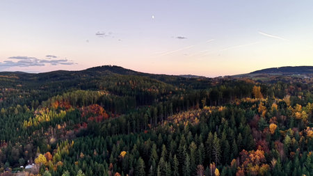 Drone captures peaceful dusk over rolling hills, Astronomer studies early stars beneath tranquil pastel sky for contentの写真素材