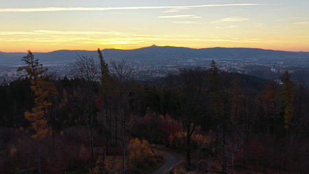 morning walk through wooded valley, tranquil nature exploration amid colorful autumn foliageの写真素材