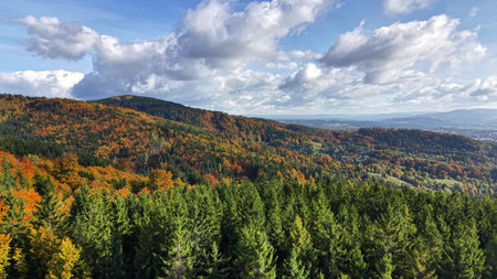 colorful mountain scene with clouds, dramatic autumn scene featuring colorful leaves and toweringの写真素材