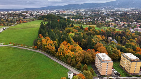 environmental evaluation of housing developments near vibrant fallcolored woodland bordersの写真素材