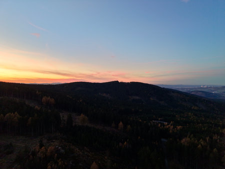 Silhouette Hills Under Fading Twilight Sky, Darkened Tree Line And Soft Color Gradient Over Valley, Moody Calmの写真素材