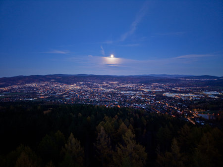 Moonlit Panoramic Cityscape Under Clear Sky, Gentle Lunar Glow Washes Rooftops And Valleys, Sparkling Streetの写真素材
