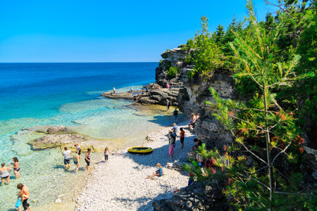 Bruce Peninsula, Georgian Bay, lake Huron, Ontario,Canada, Jul, 24, 2015, gorgeous amazing natural rocky beach view and tranquil clear water people swimming relaxing in backgroundのeditorial素材
