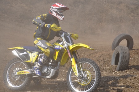 Russia, Samara, Regional Championship April 17,2010, motocross unknown rider accelerated away from the turning, dusty trailのeditorial素材